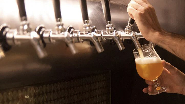 beer being poured from a tap