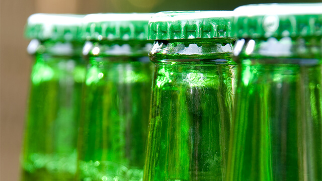 Row of green beer bottles unopened