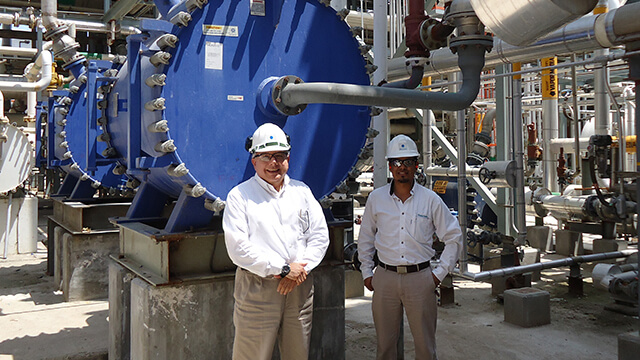 Happy customers at Mexichem in front of an installed Alfa Laval spiral heat exchanger
